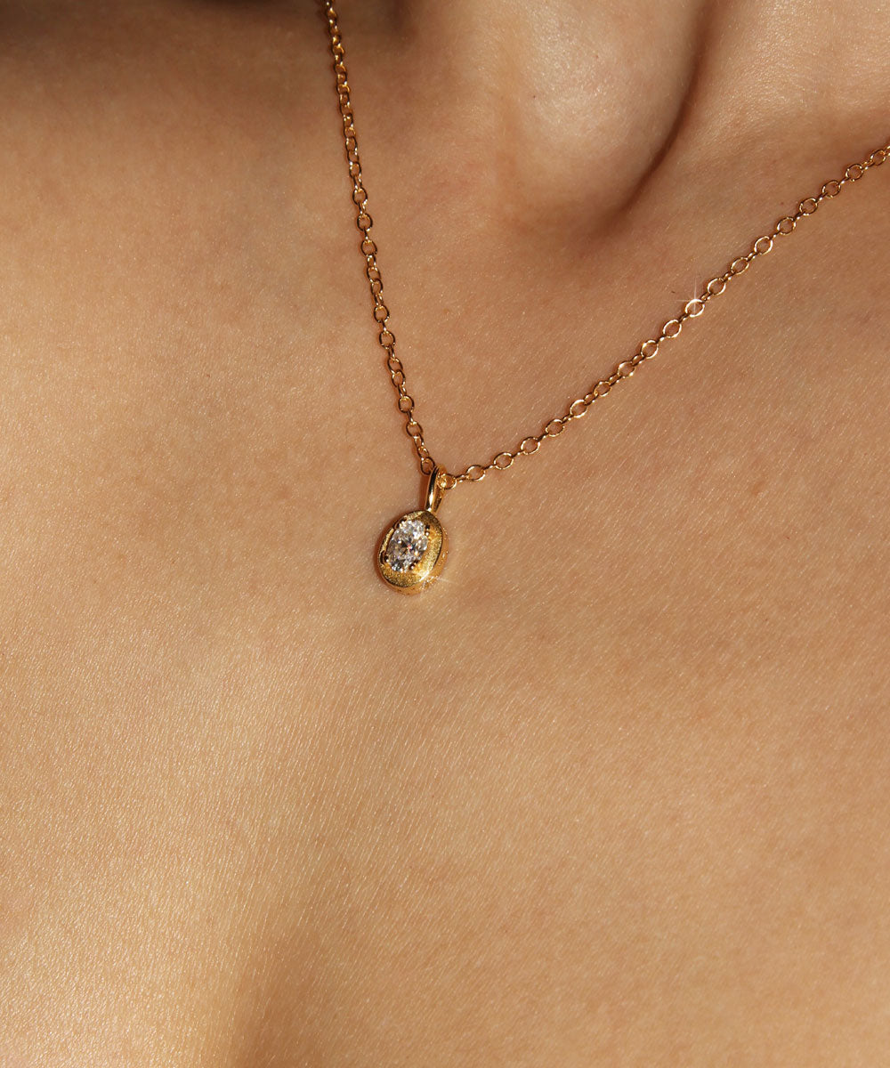 Maison de Femmes gold vermeil April Moissanite Birthstone Necklace worn by woman.