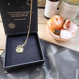 Gold Manifesting As Above So Below Spinner Necklace in black jewellery box.