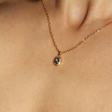 Maison de Femmes gold vermeil September Sapphire Birthstone Necklace worn by woman.