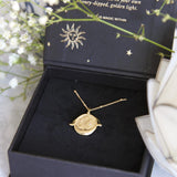 Gold Manifesting As Above So Below Spinner Necklace in black jewellery box.