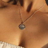 Sterling Silver Manifesting As Above So Below Spinner Necklace worn by woman.