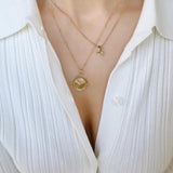Gold Manifesting As Above So Below Spinner Necklace worn by woman with a J Initial + Birthstone Charm Necklace.