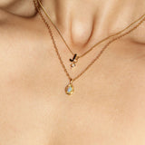 Opal Birthstone Pendant Necklace stacked with J Initial and mini Opal Birthstone Charm worn by woman.
