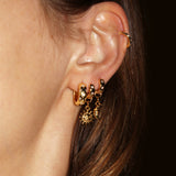 Star Studded Cosmic Celestial Hoop Earrings from the Maison de Femmes Galaxia Collection with sun and moon charms worn by woman.