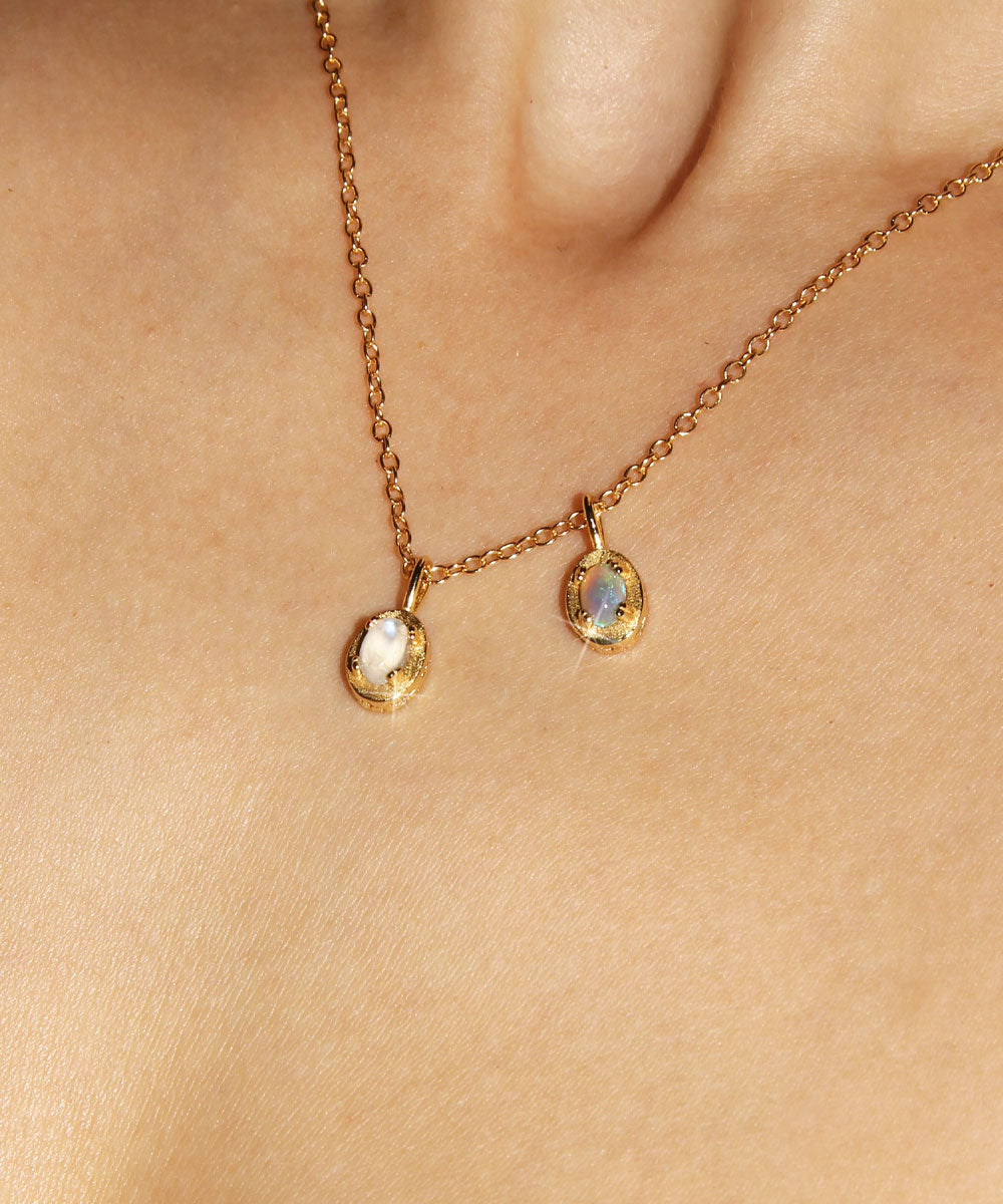 Maison de Femmes gold vermeil June Moonstone and October Opal Birthstone Necklace worn by woman.