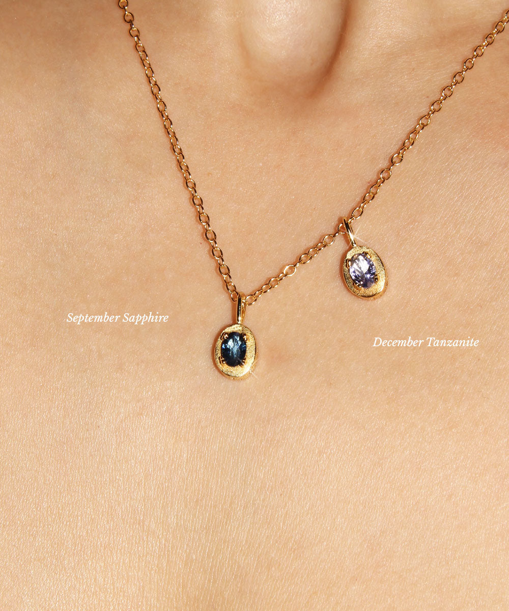 Maison de Femmes gold vermeil September Sapphire Birthstone and December Tanzanite Birthstone worn on a gold filled necklace on woman.