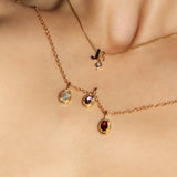 Maison de Femmes gold vermeil October Opal, February Amethyst, January Garnet Birthstone Necklace worn by woman. Stacked with J Initial and October Opal Mini Birthstone