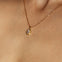 Maison de Femmes gold vermeil April Moissanite Birthstone Necklace worn by woman.