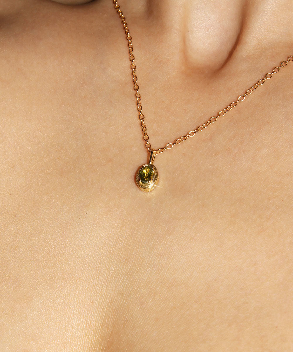 Maison de Femmes gold vermeil August Peridot Birthstone Necklace worn by woman.