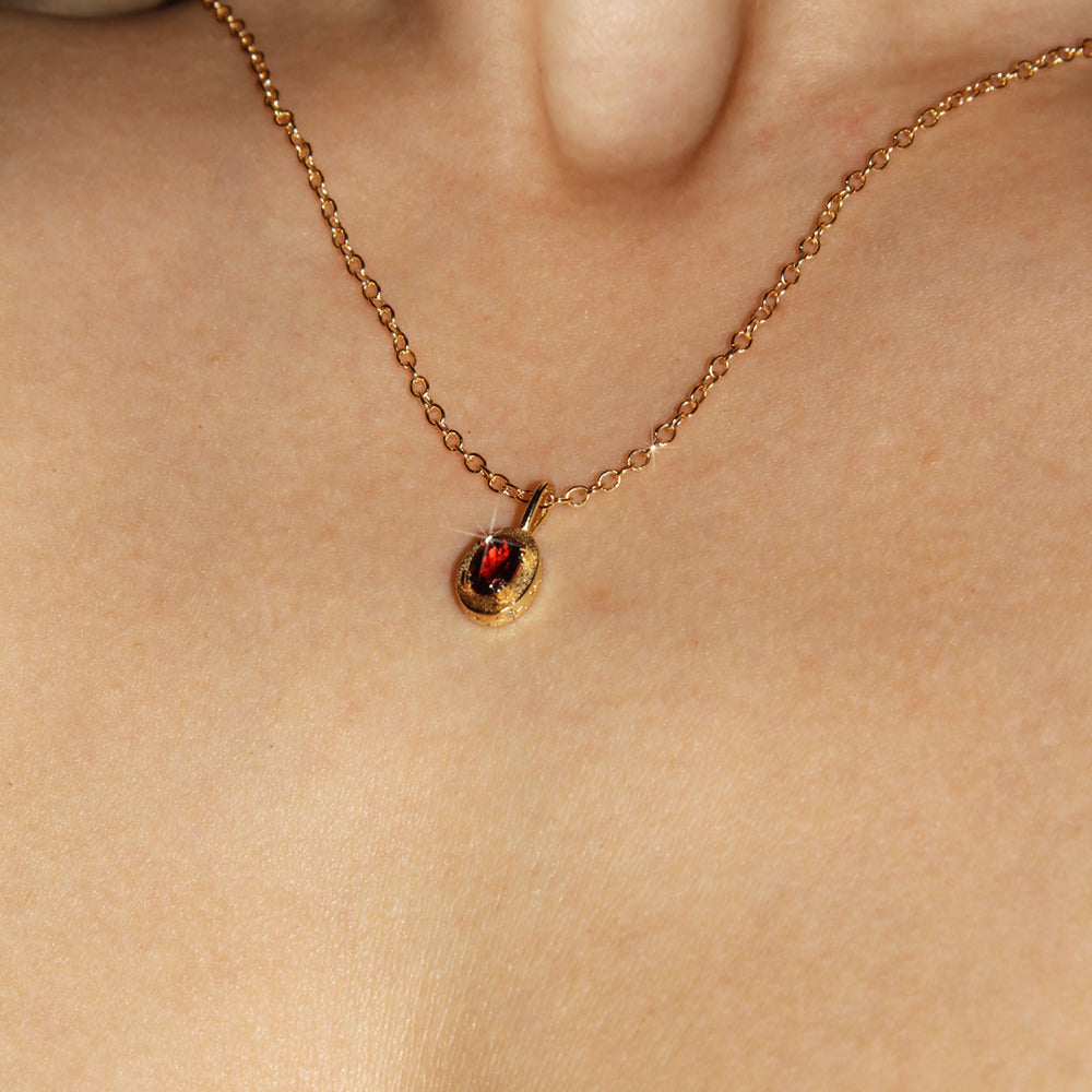 Maison de Femmes gold vermeil January Garnet Birthstone Necklace worn by woman.
