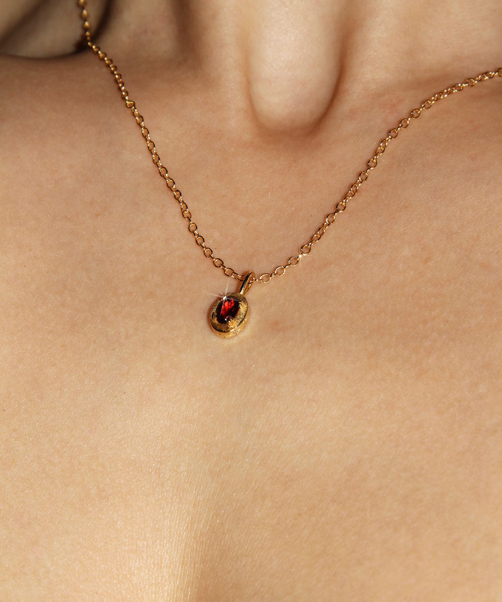 Maison de Femmes gold vermeil January Garnet Birthstone Necklace worn by woman.