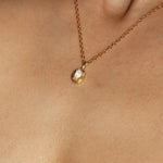 Maison de Femmes gold vermeil June Moonstone Birthstone Necklace worn by woman.