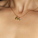 Maison de Femmes gold vermeil May Emerald, August Peridot and March Aquamarine Birthstone Necklace worn by woman.