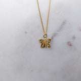 Australian gold filled butterfly charms with cosmic etchings on gold filled Curb chain necklace and a marble background.