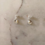 Clam shell studs with freshwater pearl.