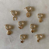 Assorted gold filled hoops with charms.